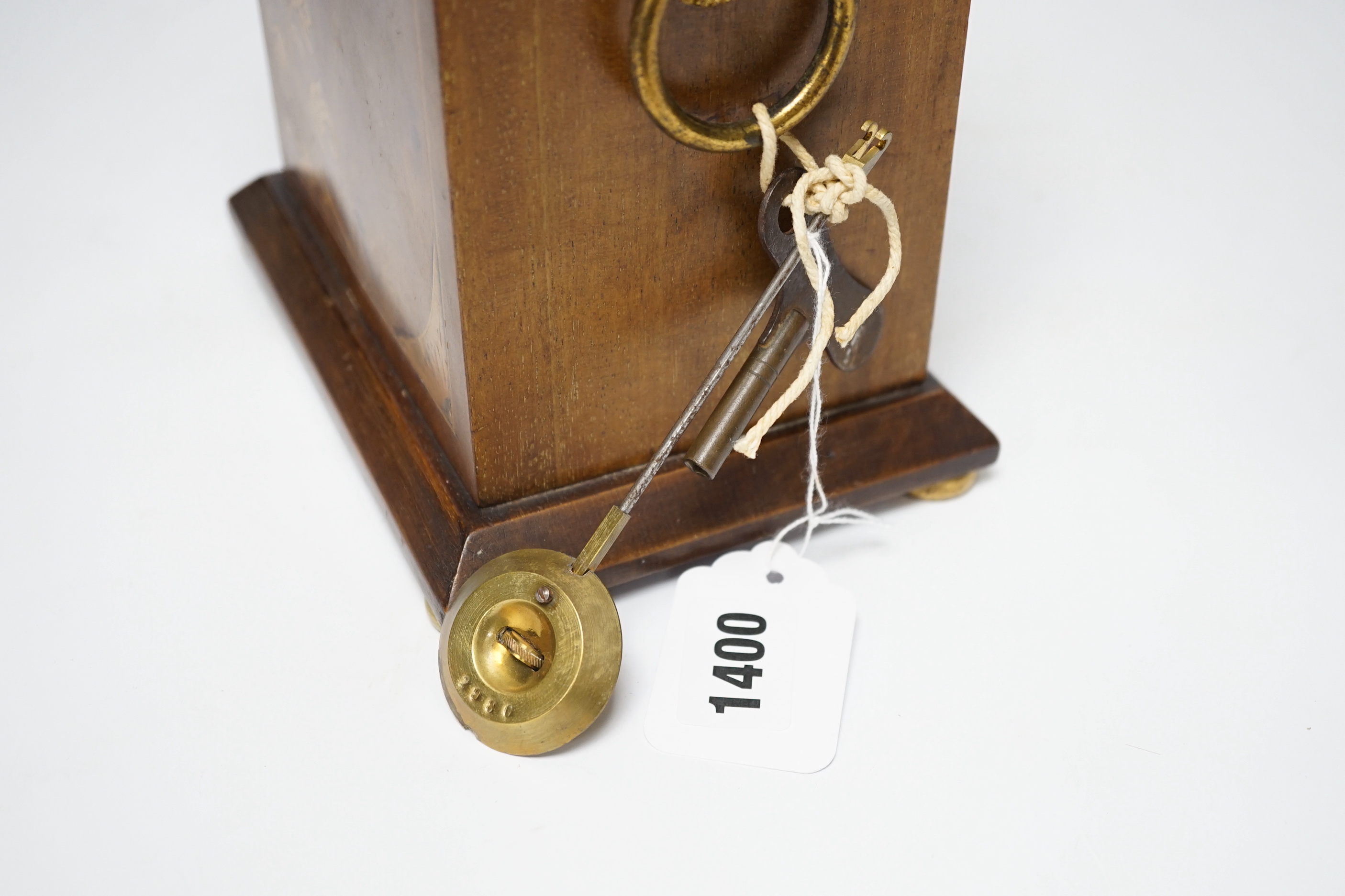 An Edwardian mahogany mantel clock, French movement striking on a coiled gong, 25cm high